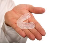 Dental mouthguard clear in hand