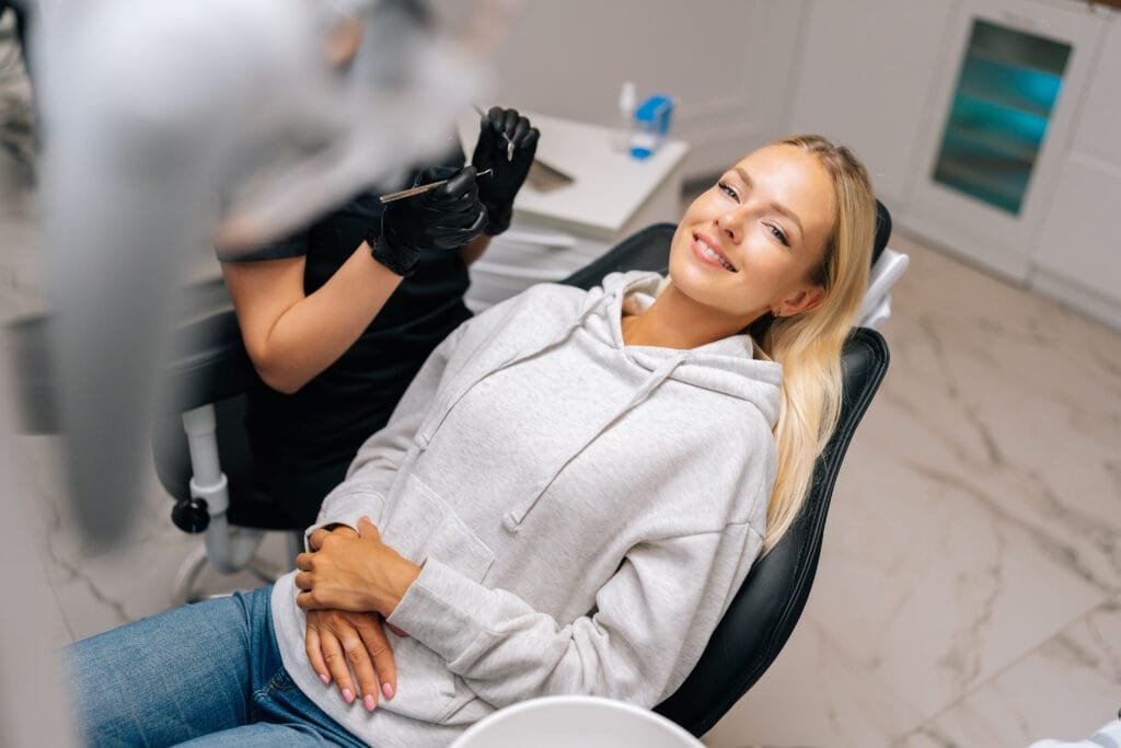 Happy patient with a perfect smile after dental treatment