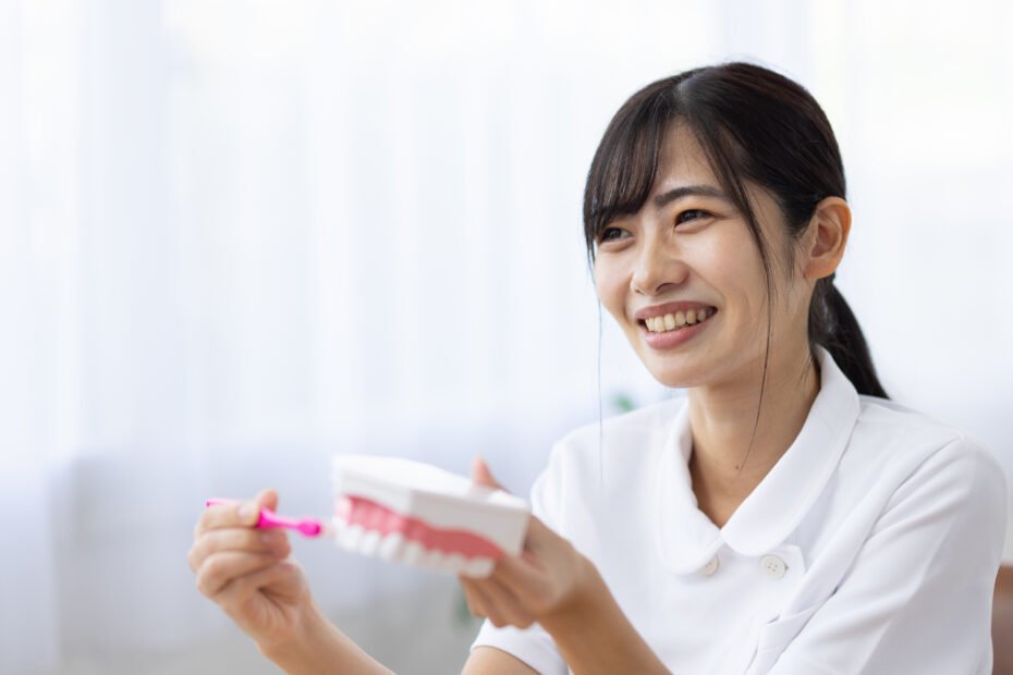 Dental hygienist teaching proper tooth brushing technique