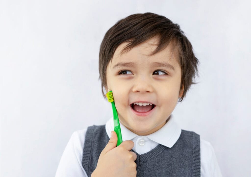 Child learning to brush teeth back at school