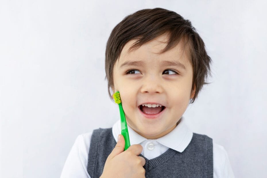 Child learning to brush teeth back at school
