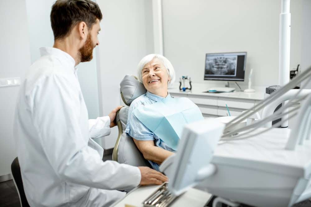 a urgent and emergency dentist ready to help a elderly patient with dental needs