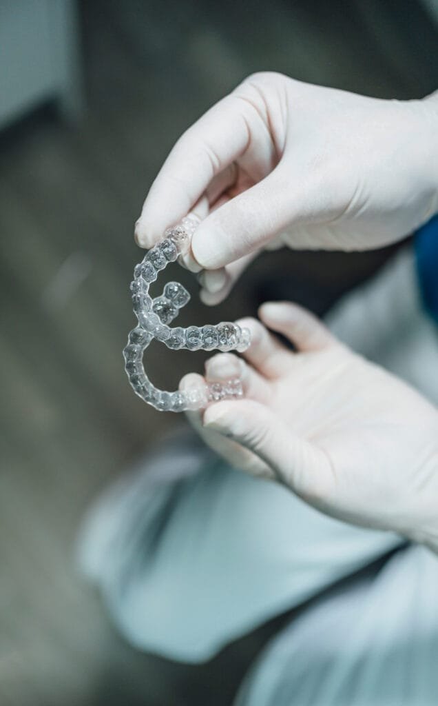 Dentist's hands showing a new set of dental aligners